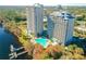 Aerial view of building exterior, pool, lake and trees at 13427 Blue Heron Beach Dr # 1205, Orlando, FL 32821