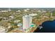 An aerial view of a lakefront highrise condominium with a pool and private dock on the water at 13427 Blue Heron Beach Dr # 1205, Orlando, FL 32821