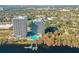 A pair of lakefront highrise condominiums with pool and dock, nestled amongst lush green and autumn foliage at 13427 Blue Heron Beach Dr # 1205, Orlando, FL 32821