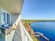 Balcony view with modern seating overlooking the beautiful lake and dock at 13427 Blue Heron Beach Dr # 1205, Orlando, FL 32821