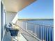 Balcony view with modern seating overlooking the beautiful lake at 13427 Blue Heron Beach Dr # 1205, Orlando, FL 32821