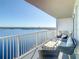 Spacious balcony with modern seating overlooking the beautiful lake at 13427 Blue Heron Beach Dr # 1205, Orlando, FL 32821