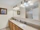 Well-lit bathroom featuring double sinks and a large mirror at 13427 Blue Heron Beach Dr # 1205, Orlando, FL 32821