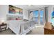 Comfortable bedroom featuring balcony access, decorative ocean view print, and plush bedding at 13427 Blue Heron Beach Dr # 1205, Orlando, FL 32821