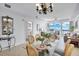 Dining area featuring stylish chandelier, dining table, and access to the living area and water view at 13427 Blue Heron Beach Dr # 1205, Orlando, FL 32821