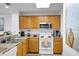 Kitchen with stainless steel microwave and white oven at 13427 Blue Heron Beach Dr # 1205, Orlando, FL 32821