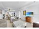 Bright living room with comfortable seating, tile floors, and a view of the beach on TV at 13427 Blue Heron Beach Dr # 1205, Orlando, FL 32821