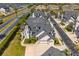 Aerial view of a well-manicured neighborhood with townhomes, lush landscaping, and paved streets at 13429 Fountainbleau Dr # 13429, Clermont, FL 34711