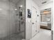 Modern bathroom featuring a glass-enclosed shower and a glimpse of the bedroom at 13429 Fountainbleau Dr # 13429, Clermont, FL 34711