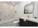 Stylish bathroom with a stone accent wall, modern vanity, and a soaking tub at 13429 Fountainbleau Dr # 13429, Clermont, FL 34711