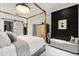 Stylish bedroom boasts a four-poster bed, modern decor, and sleek, black accent wall at 13429 Fountainbleau Dr # 13429, Clermont, FL 34711
