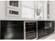 Modern butler's pantry features a wine cooler, storage, and quartz countertops at 13429 Fountainbleau Dr # 13429, Clermont, FL 34711