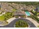 Overhead view of the clubhouse, community pool, parking lot, and beautiful landscaping at 13429 Fountainbleau Dr # 13429, Clermont, FL 34711