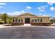Front view of the community clubhouse with manicured landscaping at 13429 Fountainbleau Dr # 13429, Clermont, FL 34711