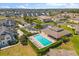 Aerial view of the community pool surrounded by manicured landscaping and beautiful neighborhood at 13429 Fountainbleau Dr # 13429, Clermont, FL 34711