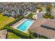 Community pool with sundeck surrounded by manicured landscaping and lush green grass at 13429 Fountainbleau Dr # 13429, Clermont, FL 34711
