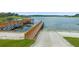 Wide view of a wooden dock, boat ramp, and waterfront of the lake at 13429 Fountainbleau Dr # 13429, Clermont, FL 34711
