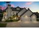 Elegant two-story home featuring a three-car garage, manicured landscaping, and classic architectural details at 13429 Fountainbleau Dr # 13429, Clermont, FL 34711