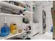 Spacious laundry area with shelving, ample storage, stacked washer/dryer, and plenty of supplies at 13429 Fountainbleau Dr # 13429, Clermont, FL 34711