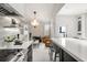 Modern kitchen flowing into a living area, featuring high-end appliances and unique lighting at 13429 Fountainbleau Dr # 13429, Clermont, FL 34711
