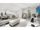 Light-filled living room with modern furniture and a view of the bathroom at 13429 Fountainbleau Dr # 13429, Clermont, FL 34711