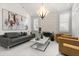 Bright living room with a stone fireplace, contemporary furniture, and an artistic chandelier at 13429 Fountainbleau Dr # 13429, Clermont, FL 34711