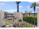 Outdoor patio area featuring a grill, black iron railing, and a beautiful garden view at 13429 Fountainbleau Dr # 13429, Clermont, FL 34711
