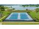 Community tennis courts with net and fencing along waterfront at 13429 Fountainbleau Dr # 13429, Clermont, FL 34711