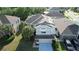 Aerial view of a home featuring solar panels, a two-car garage, and mature landscaping at 13520 Meadow Bay Loop, Orlando, FL 32824