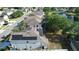 Aerial view of homes with solar panels with a pond nearby in a well-maintained community at 13520 Meadow Bay Loop, Orlando, FL 32824