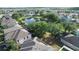 Expansive community aerial view featuring a serene pond, mature trees, and well-maintained homes at 13520 Meadow Bay Loop, Orlando, FL 32824