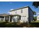 The back of a two-story home with ample windows and a screened in porch at 13520 Meadow Bay Loop, Orlando, FL 32824