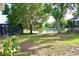 Large backyard with beautiful water view and mature shade trees at 13520 Meadow Bay Loop, Orlando, FL 32824