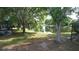 Lush backyard view features mature trees and a pond, providing a tranquil and private outdoor space at 13520 Meadow Bay Loop, Orlando, FL 32824