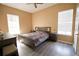 This bedroom features wood floors, large windows, and a ceiling fan at 13520 Meadow Bay Loop, Orlando, FL 32824