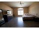 Spacious bedroom with wood floors, large window, and ceiling fan; includes crib, dresser, and mirror at 13520 Meadow Bay Loop, Orlando, FL 32824