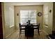 Cozy dining room with tile floors and a large picture window at 13520 Meadow Bay Loop, Orlando, FL 32824
