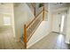 The foyer has ceramic tile flooring, a staircase, and natural light streaming through a window at 13520 Meadow Bay Loop, Orlando, FL 32824