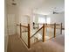 This hallway features carpet, a staircase, and neutral-colored walls at 13520 Meadow Bay Loop, Orlando, FL 32824