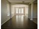 Open-concept living room with wood floors and view into the dining room at 13520 Meadow Bay Loop, Orlando, FL 32824