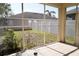 A view from the screened in porch looking out to the backyard and the white fence at 13520 Meadow Bay Loop, Orlando, FL 32824