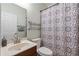 Neutral bathroom with a vanity sink, commode, mirror, and decorative shower curtain, creating a functional space at 1530 Tally Cir, Oviedo, FL 32765