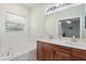 Well-lit bathroom featuring a double vanity and a soaking tub at 1530 Tally Cir, Oviedo, FL 32765