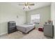 Cozy bedroom with neutral decor, ceiling fan, and ample natural light from the large window at 1530 Tally Cir, Oviedo, FL 32765