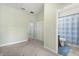 Inviting bedroom with carpeted floors and attached bathroom with a shower-tub, offering convenient relaxation and privacy at 1530 Tally Cir, Oviedo, FL 32765