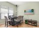 Light-filled dining area with modern table set, and a view of the backyard at 1530 Tally Cir, Oviedo, FL 32765