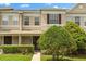 Two-story home with neutral exterior paint, attractive landscaping, and well-maintained lawn at 1530 Tally Cir, Oviedo, FL 32765