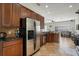 Modern kitchen boasts stainless steel appliances, granite countertops, and dark wood cabinetry at 1530 Tally Cir, Oviedo, FL 32765