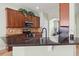 Modern kitchen features granite countertops, stainless steel appliances, and wooden cabinets at 1530 Tally Cir, Oviedo, FL 32765
