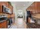 Contemporary kitchen with stainless steel appliances, dark cabinetry, and tiled flooring at 1530 Tally Cir, Oviedo, FL 32765